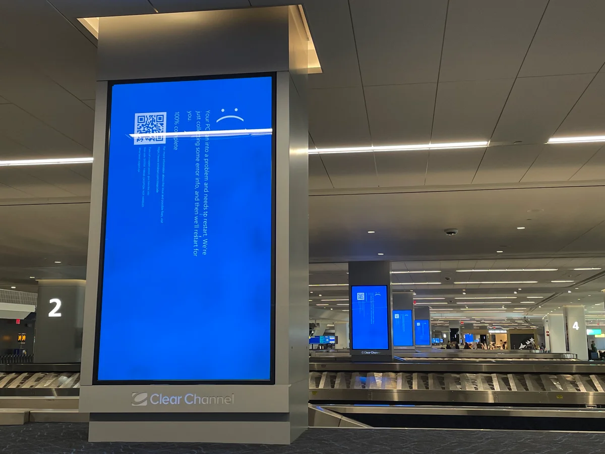 Windows Blue Screen of Death displayed on an airport departure board