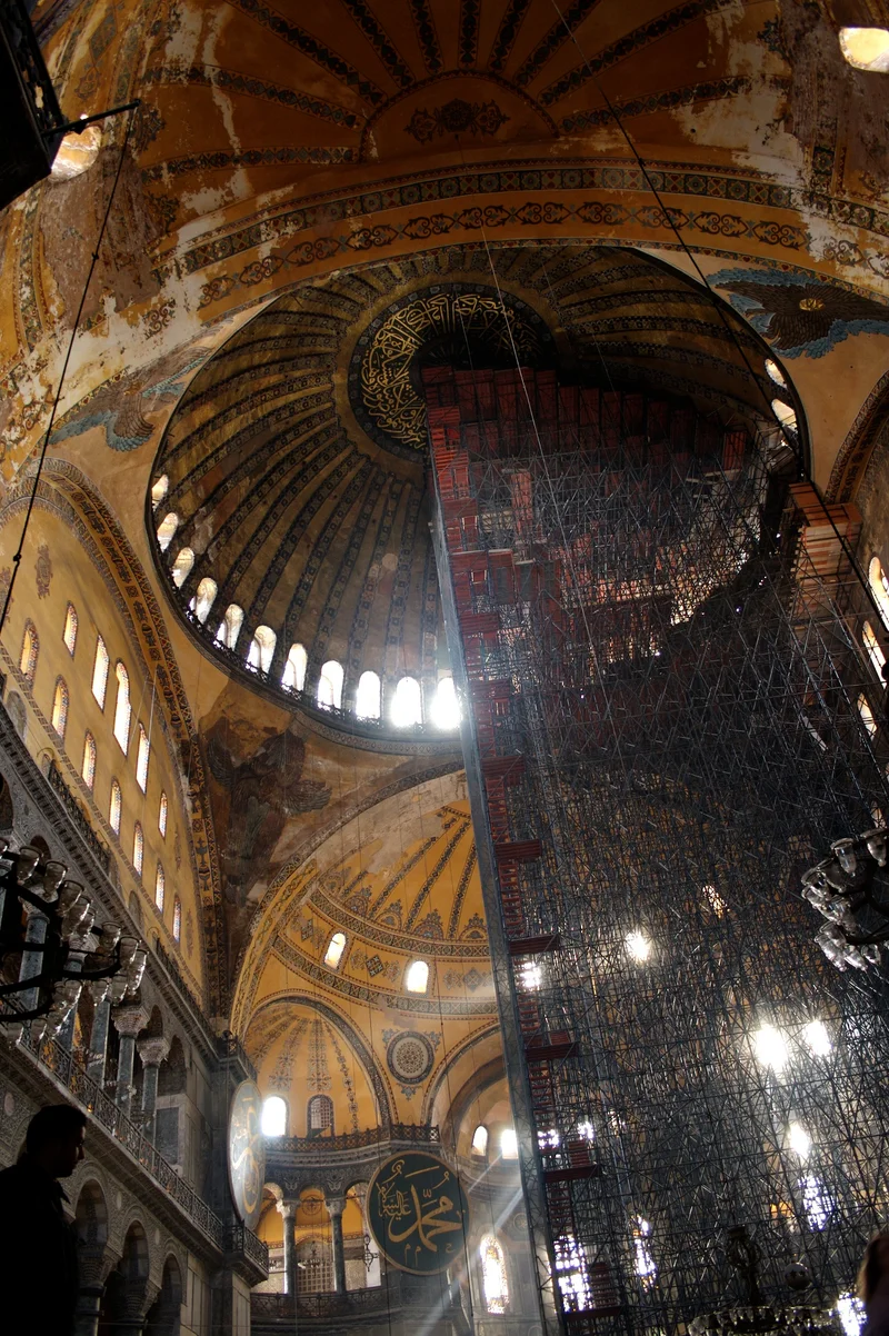 Interior of the Hagia Sophia looking up at the dome, showing the ring of windows at the base and the vast curved ceiling
